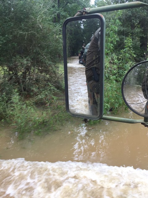   Leading a convoy of supplies into the flood waters.